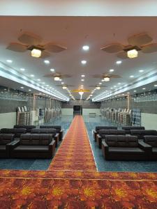 a large room with couches and a red carpet at Ram Hari Hara Convention in Khammam