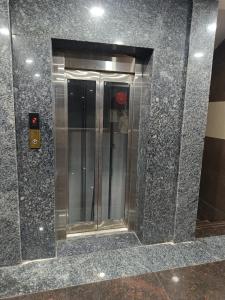 a reflection of a elevator in a building at Ram Hari Hara Convention in Khammam