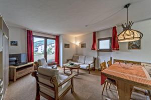 a living room with a table and a dining room at Chesa Chamuotsch - Celerina in Celerina