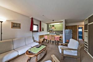 a living room with a couch and a table at Chesa Chamuotsch - Celerina in Celerina