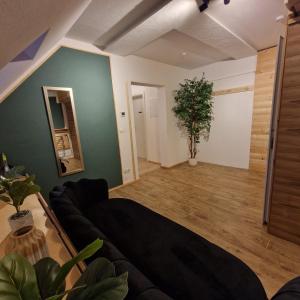 a living room with a couch and a mirror at Ferienwohnung Sunny 2 in Mittenwalde +8 photos