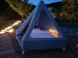 a blue canopy bed with lights on a deck at La Torre in Pavullo nel Frignano