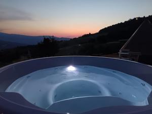 a bath tub with a sunset in the background at La Torre in Pavullo nel Frignano +1 photo