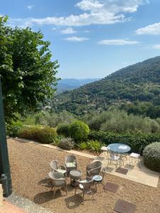 a patio with chairs and a table with a view at La Bastide Sainte Thérèse in Grasse