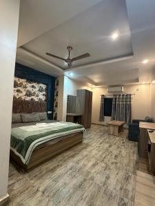 a bedroom with a bed and a ceiling fan at Sakhiya Fish Resort Pvt Ltd in Chhapia +2 photos