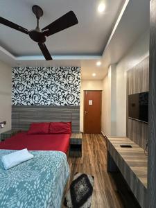 a bedroom with a red bed and a ceiling fan at Sakhiya Fish Resort Pvt Ltd in Chhapia