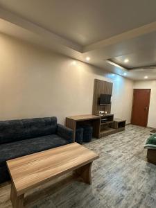 a living room with a couch and a table at Sakhiya Fish Resort Pvt Ltd in Chhapia