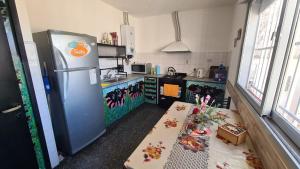 a kitchen with a refrigerator and a table in it at El Tesoro Cordobés in Córdoba
