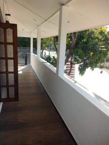 a corridor of a building with a door and a tree at Aluthwewa Gate in Angunakolapelessa +6 photos