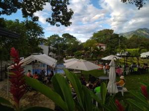 a group of people sitting under umbrellas at Llano grande rivera in Rivera
