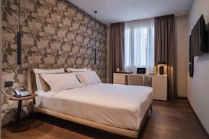 a bedroom with a bed and a wall at Porpora Suite Hotel in Milan