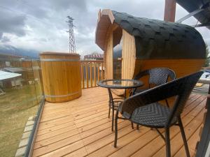 a balcony with a table and chairs on a deck at Loft Chalet Bansko in Bansko