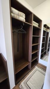 a walk in closet with wooden shelves at Szende Vendégház in Villány