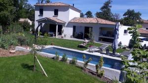 a house with a swimming pool in a yard at Le Saint Jacques in Nans-les-Pins