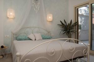 a bedroom with a white bed with pillows on it at Beach House Lefkes B in Zakynthos