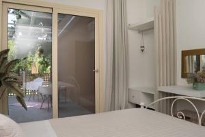 a bedroom with a door leading to a patio at Beach House Lefkes B in Zakynthos