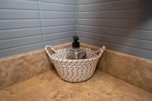 a bottle of water in a basket on a counter at Mumtaz Dar in Marrakesh