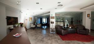 a living room with a table and chairs and a dining room at Hotel Restaurante Canzana in Pola de Laviana