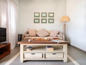 a living room with a couch and a coffee table at Heliades Maisonettes in Mythimna