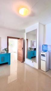 a living room with a large mirror and blue cabinets at Blue Island Punta Rucia in Punta Rucia