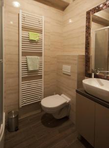 a bathroom with a toilet and a sink at Apartment Butterfly in Osijek +10 photos