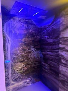 a waterfall in a room with a rock wall at Hotel Joli in San Marino +81 photos