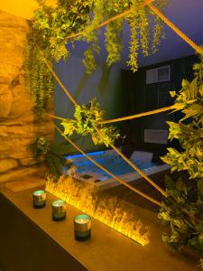 a room with plants and candles on a table at Hotel Joli in San Marino