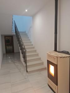 a staircase with a fireplace in the middle of a room at MTB b&b in Alfonsine