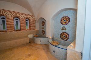a bathroom with two tubs in a room with windows at Mumtaz Dar in Marrakesh +99 photos