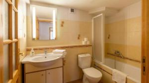 a bathroom with a sink and a toilet and a mirror at CHALUPA V ZÁPADNÝCH TATRÁCH in Bobrovec +42 photos