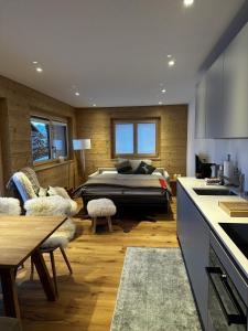 a bedroom with a bed in the middle of a room at Chalet Sofia in Bettmeralp