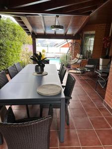 a dining table and chairs on a patio at !Chalet de lujo para vacaciones!... in Camargo