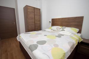 a bedroom with a bed with a polka dot bedspread at Apartment Butterfly in Osijek