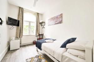 a bedroom with a bed and a tv and a window at City London Hotel in London