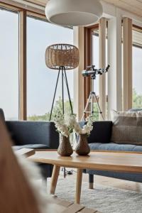 a living room with a couch and a coffee table at Seaside Cottage At Bønnerup Strand in Glesborg