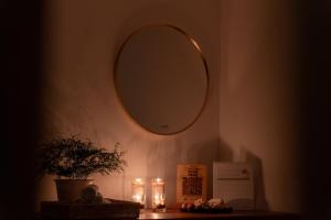 a mirror on a wall with a table with candles at Orca Dickwella in Dickwella