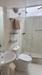 a bathroom with a toilet and a shower and a sink at Casa Elena in Cusco +9 photos