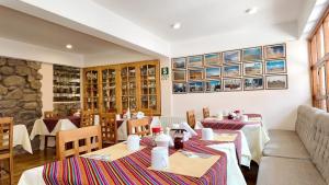 a dining room with tables and chairs in a restaurant at Casa Elena in Cusco