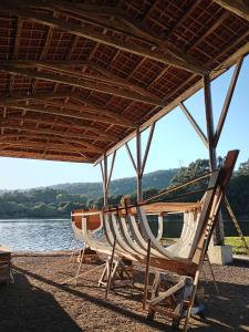 a group of adirondack chairs and a boat on a beach at O MIRADOR da RÍA in Outes