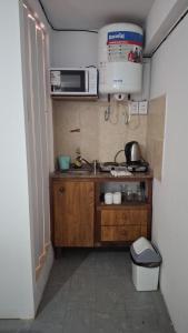 a small kitchen with a sink and a microwave at SLC San Martín 4 in San Luis