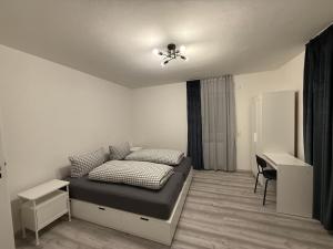 a bedroom with a bed and a desk in it at Sofia2 in Urschmitt