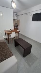 a living room with a wooden table and a dining room at SLC San Martín 4 in San Luis