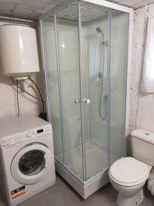a shower stall in a bathroom with a washing machine at Octavie in Villeurbanne