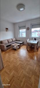 a living room with a couch and a table at Apartments Padrino BP in Bosanski Novi