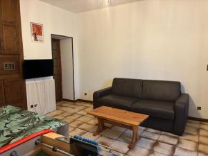 a living room with a couch and a coffee table at La petite maison in Rimaucourt +2 photos