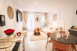 a living room with a couch and a table at Confort & Charme in Grignols