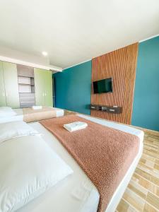 a hotel room with two beds and a flat screen tv at Kindia Park Hotel in La Esmeralda
