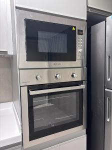 a stainless steel oven with a microwave in a kitchen at شقة في دار المشاعر in Mecca