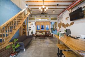 a living room with a couch and a staircase at My Guesthouse 109 - SELF CHECK IN in George Town