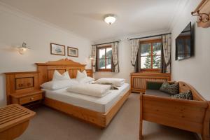 a bedroom with a large bed and a couch at Brandhof in Ramsau am Dachstein